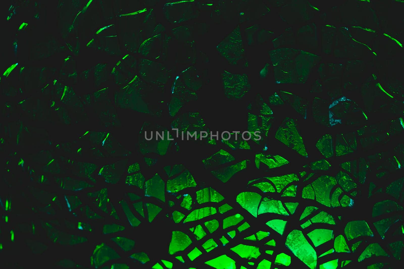 Shattered transparent glass pattern in the dark. abstract cracked background