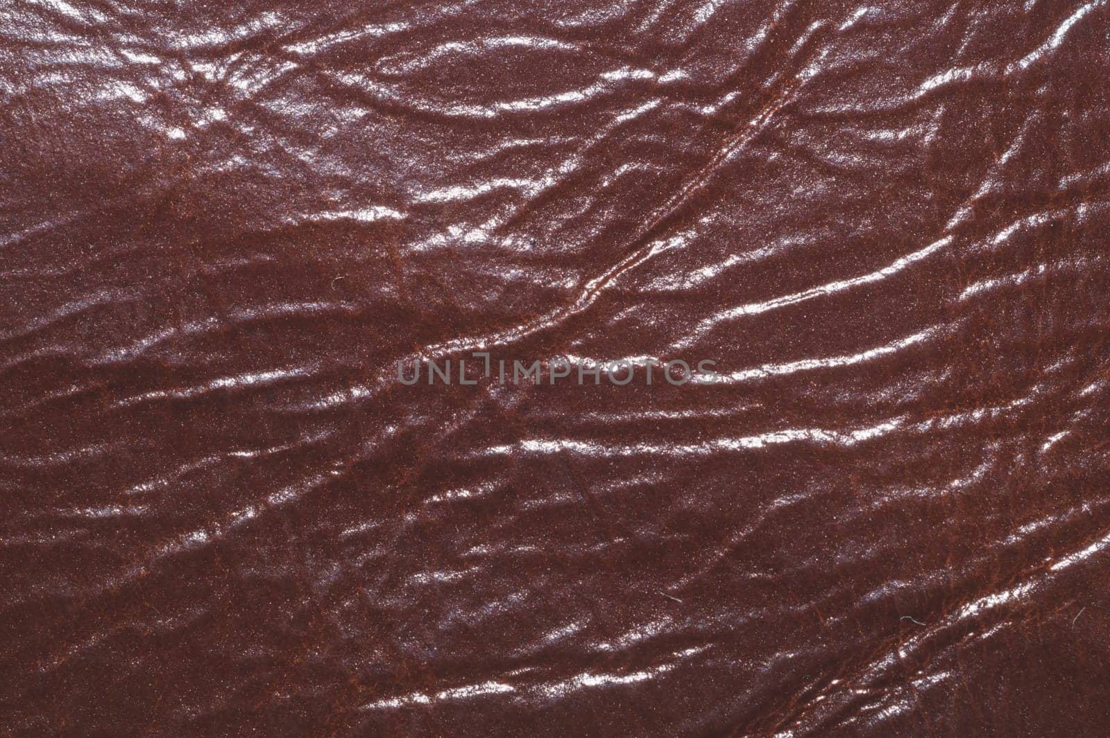 Dark brown leather with wrinkled lines close up