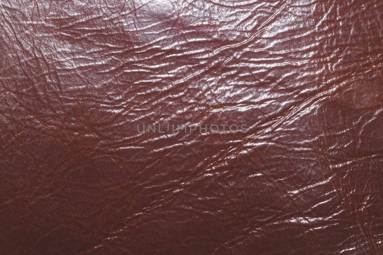 Dark brown leather with wrinkled lines close up