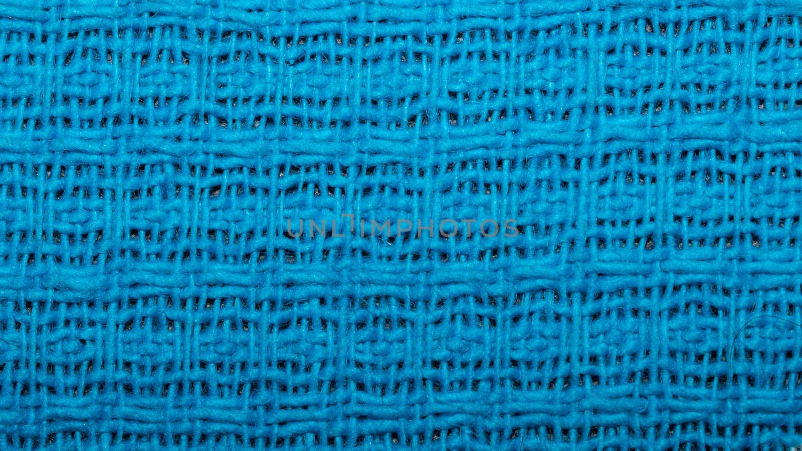 Blue fabric background with waffle pattern close up