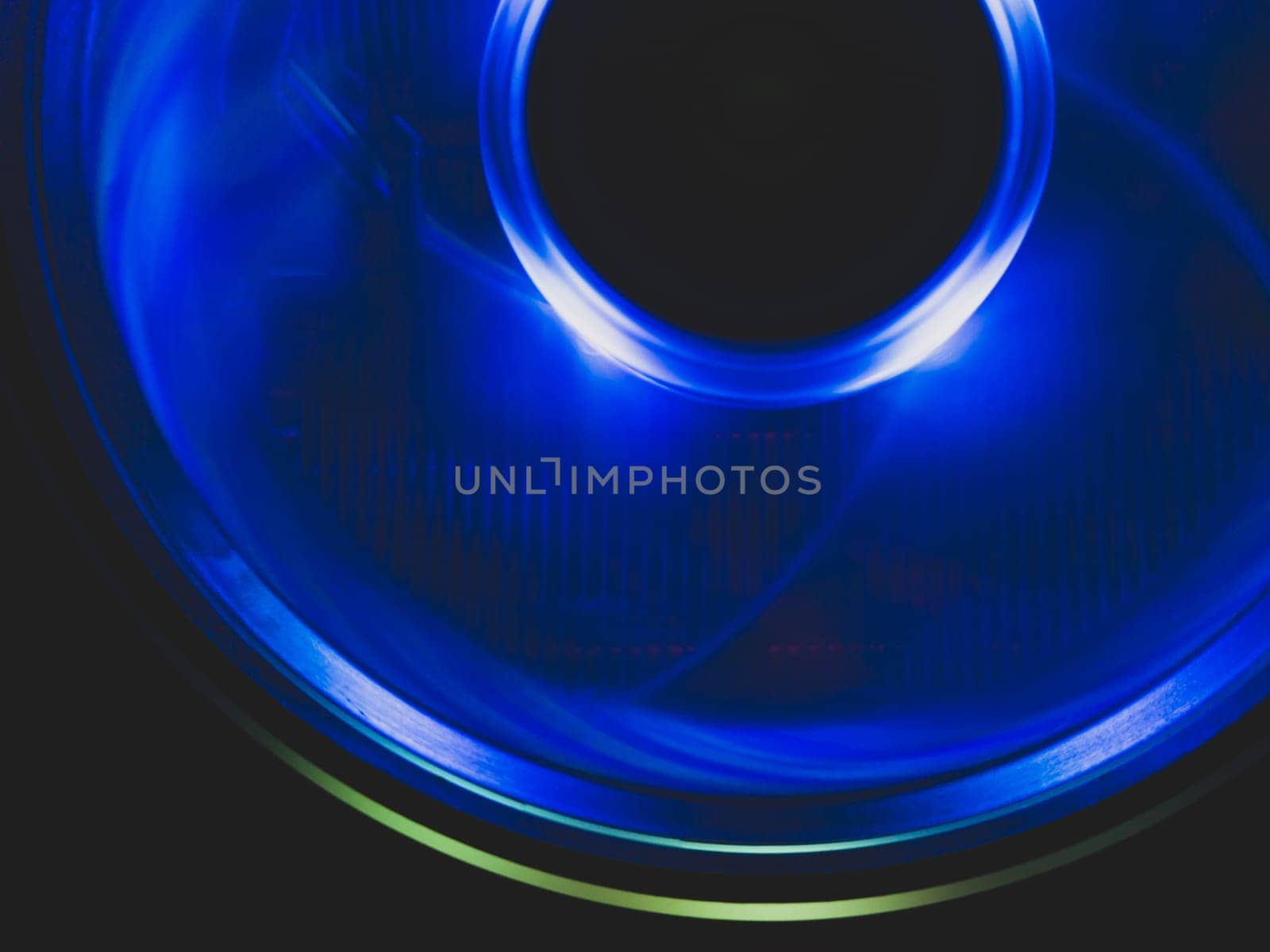 Computer cooling fan with blue light abstract background. cooler in action with led close up. power in motion concept