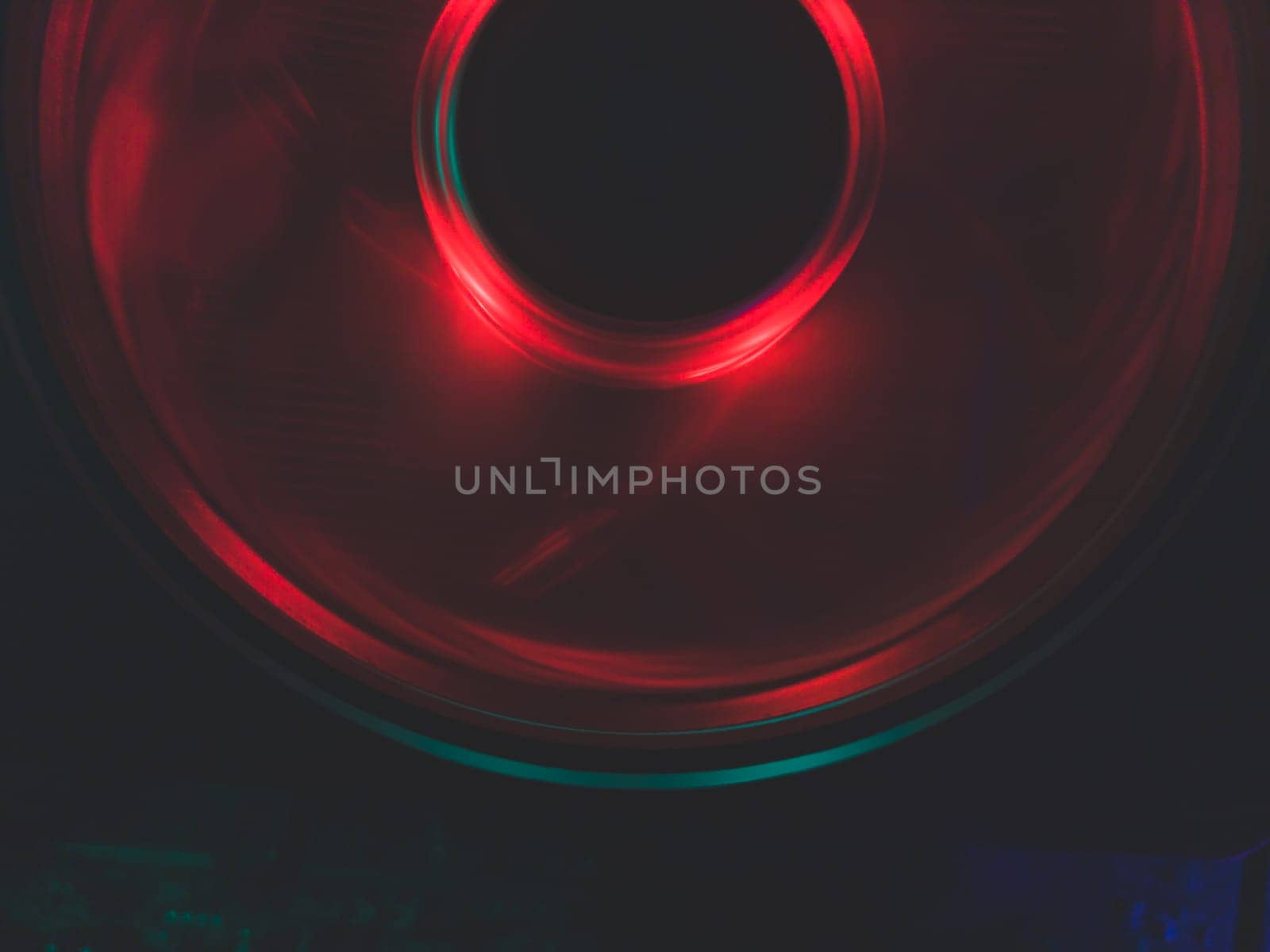 Red light of computer fan close up. cooler in action with leds. abstract background. power in motion concept