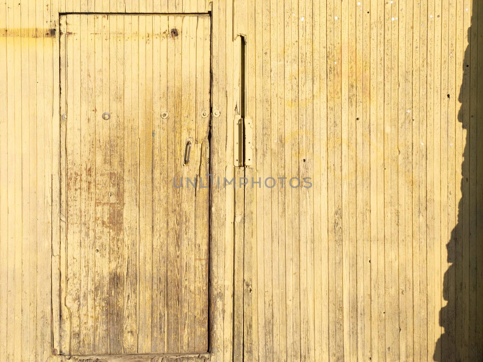 Wooden plank door in wooden wall. barn entrance