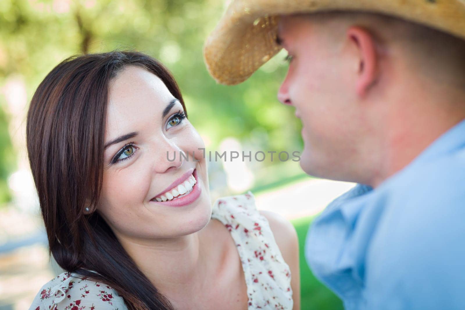Happy Romantic Caucasian Couple Talking in the Park.