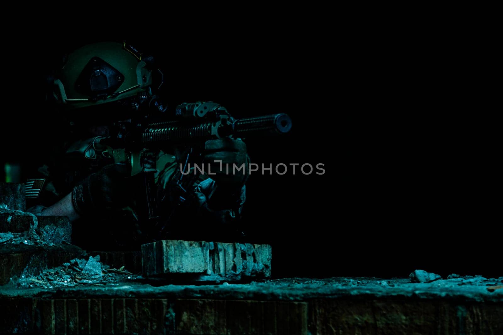 Marksman in action in the ruined city under cover of darkness