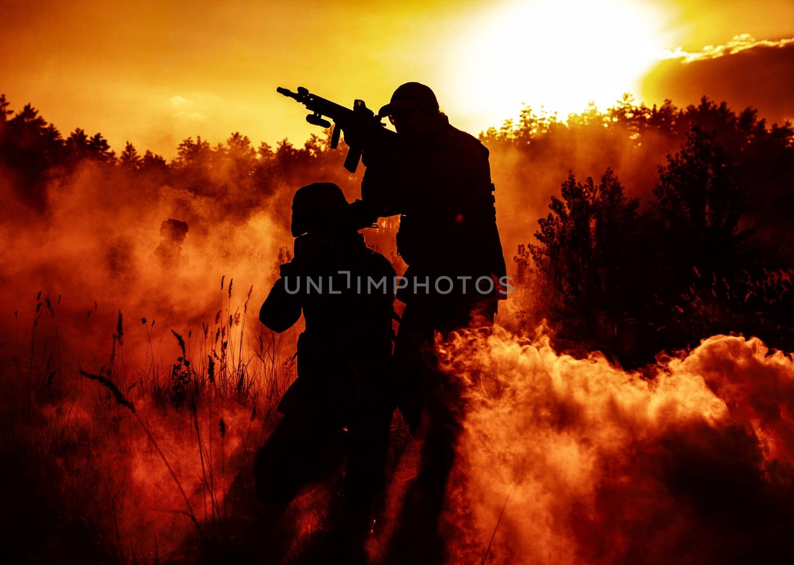 United States Marines in action. Military action, desert battlefield, smoke grenades., fire and explosions. Sun setting, dark silhouettes in the desert
