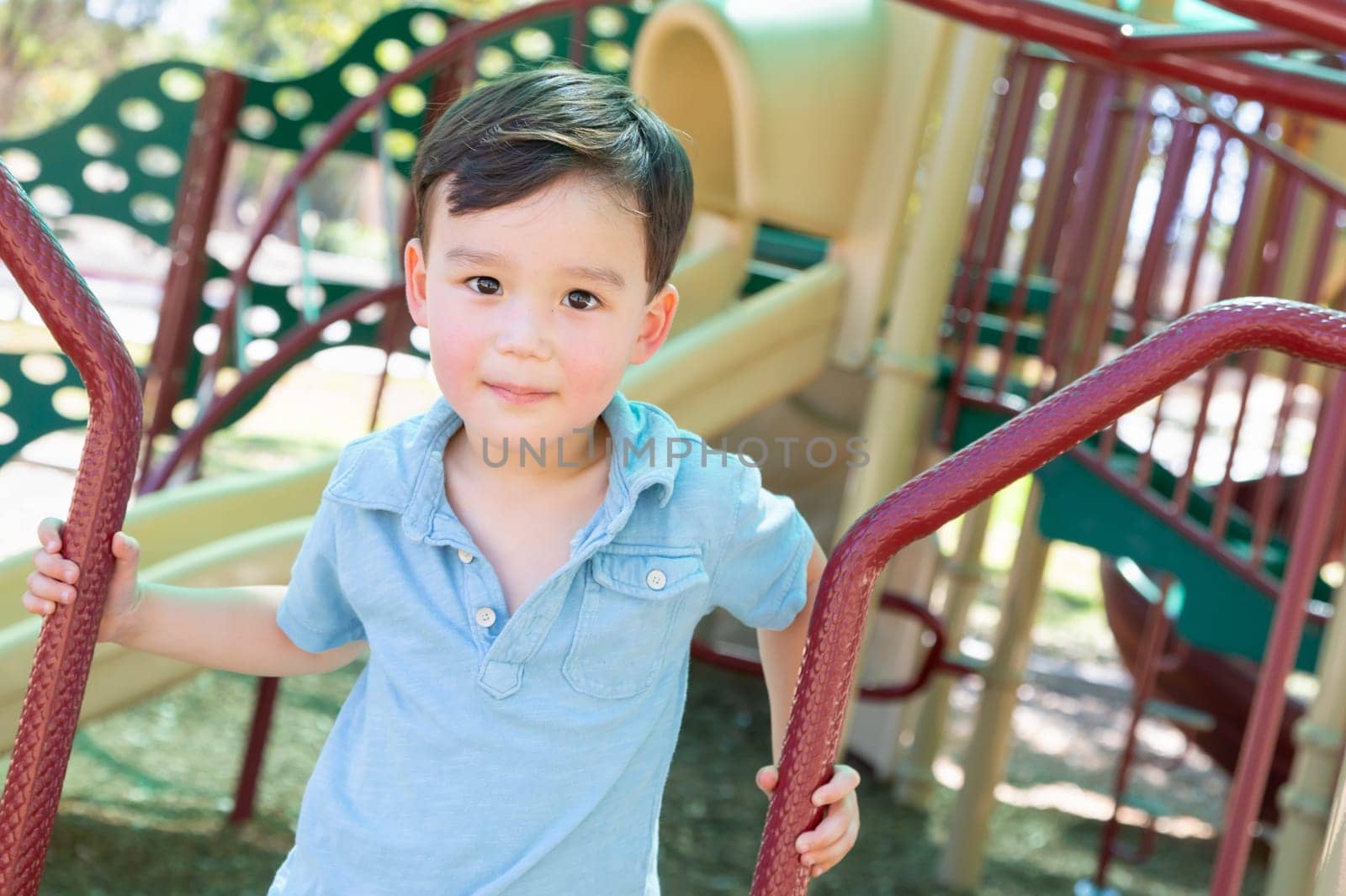 Chinese and Caucasian Boy Having Fun At The Playground.