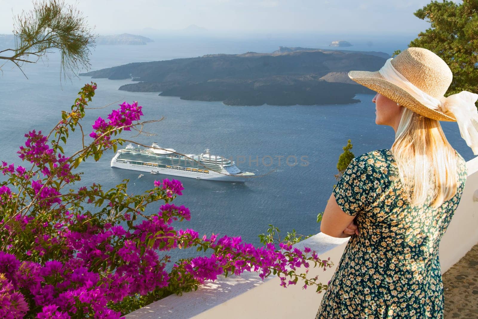 Female Tourist Admiring the View of the Cruise Ship Off the Coast of Santorini Greece.