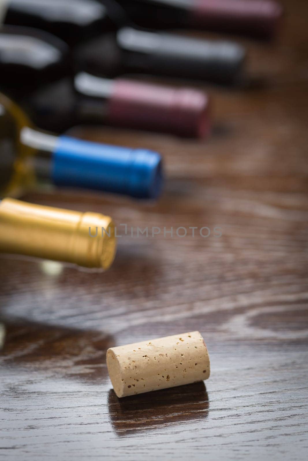 Wine Bottles and Cork on a Reflective Wood Surface Abstract.