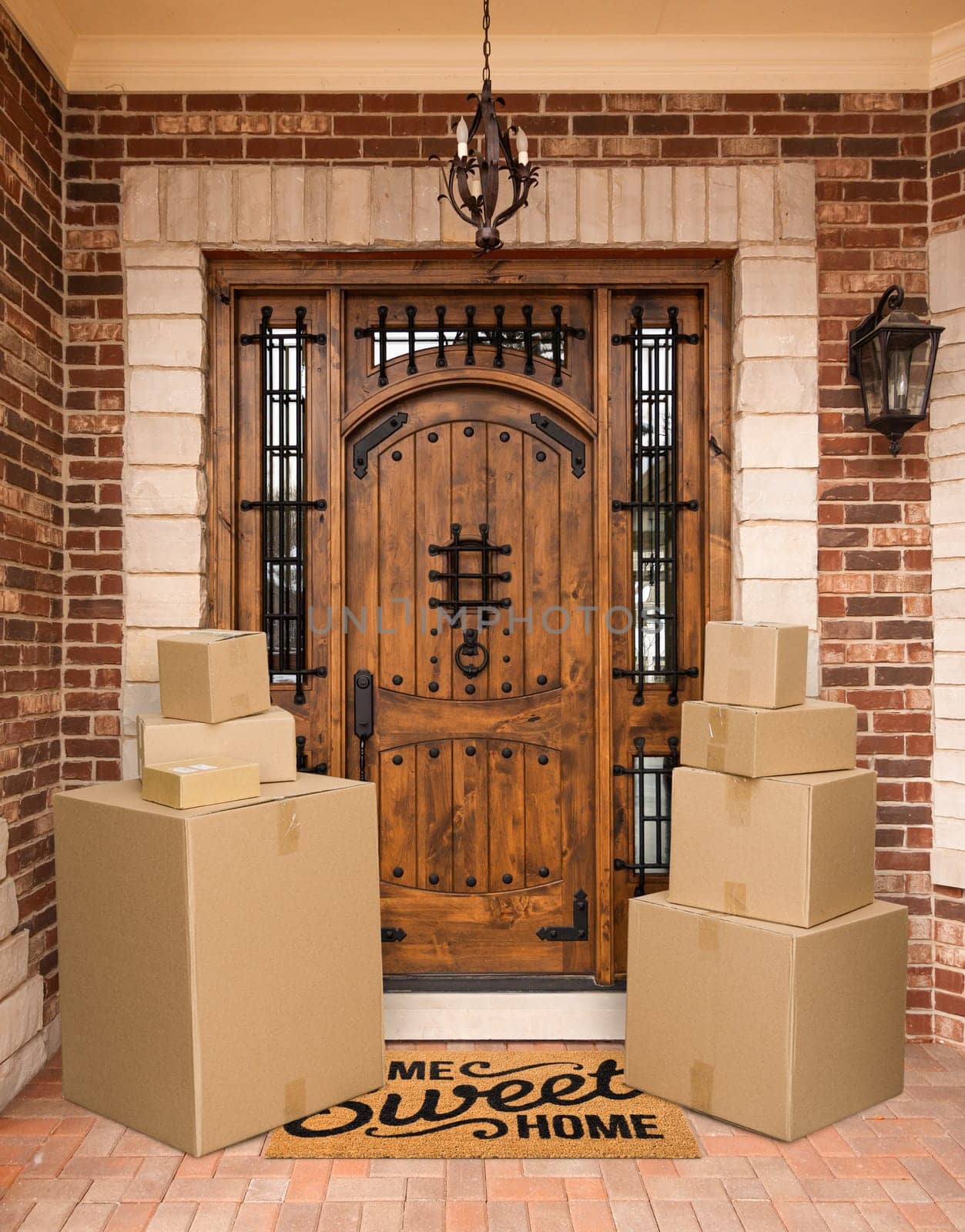 Several Packages Sitting on Home Sweet Home Welcome Mat At Front Door of House.