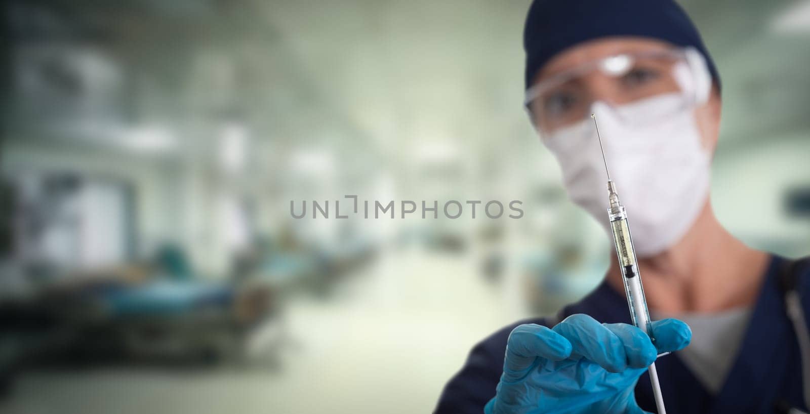 Doctor or Nurse Holding Medical Syringe with Needle Within Hospital.