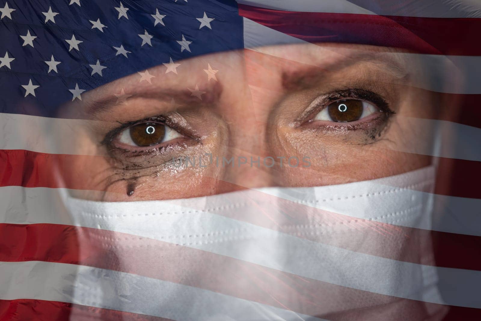 Tearful Stressed Female Doctor or Nurse Wearing Medical Face Mask on Ghosted American Flag Background.