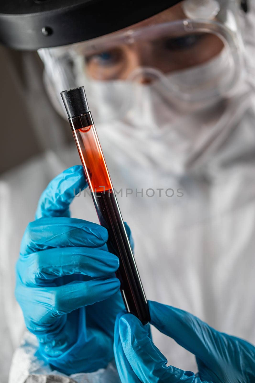 Female Lab Worker Holds Test Tube of Blood For Testing.