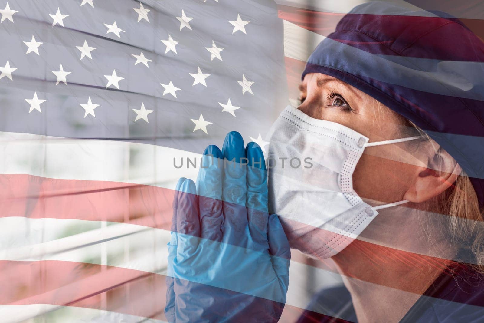Prayerful Stressed Female Doctor or Nurse On Break At Window Wearing Medical Face Mask.