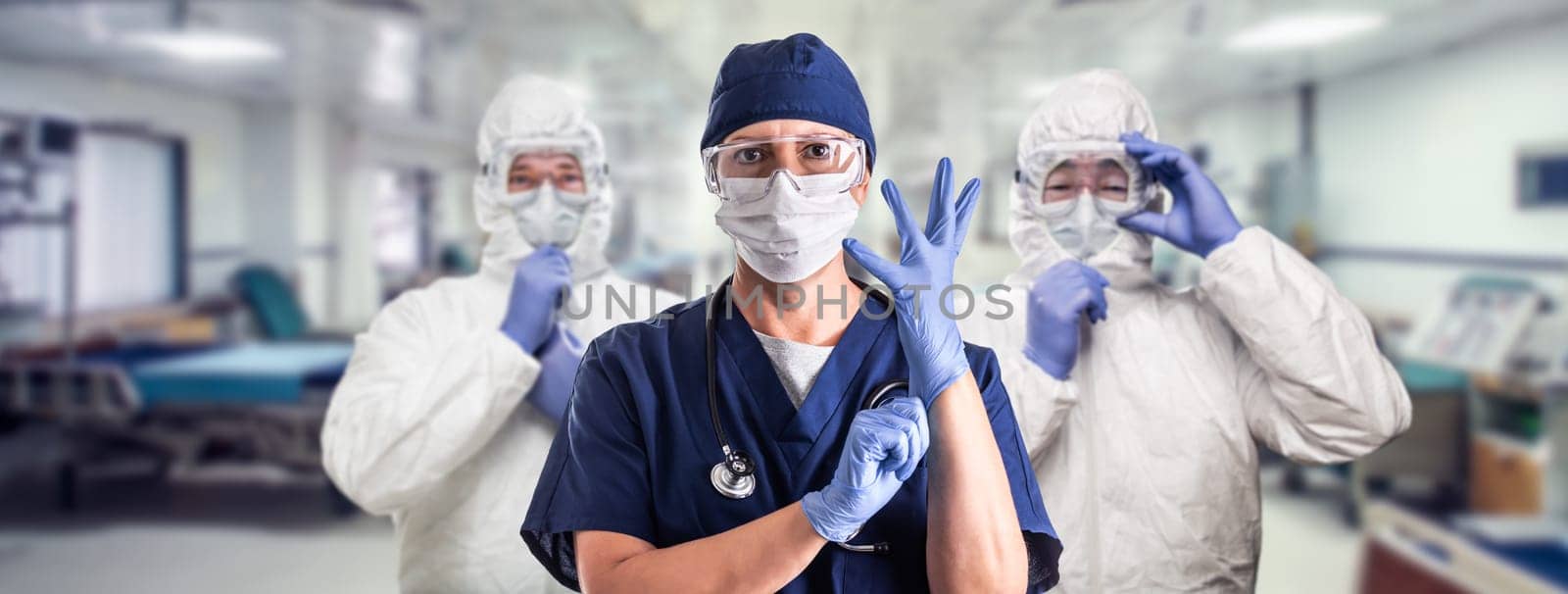 Team of Female and Male Doctors or Nurses Wearing Personal Protective Equiment In Hospital Emergency Room.