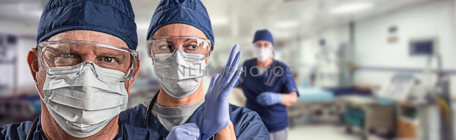 Team of Female and Male Doctors or Nurses Wearing Personal Protective Equiment In Hospital Emergency Room.