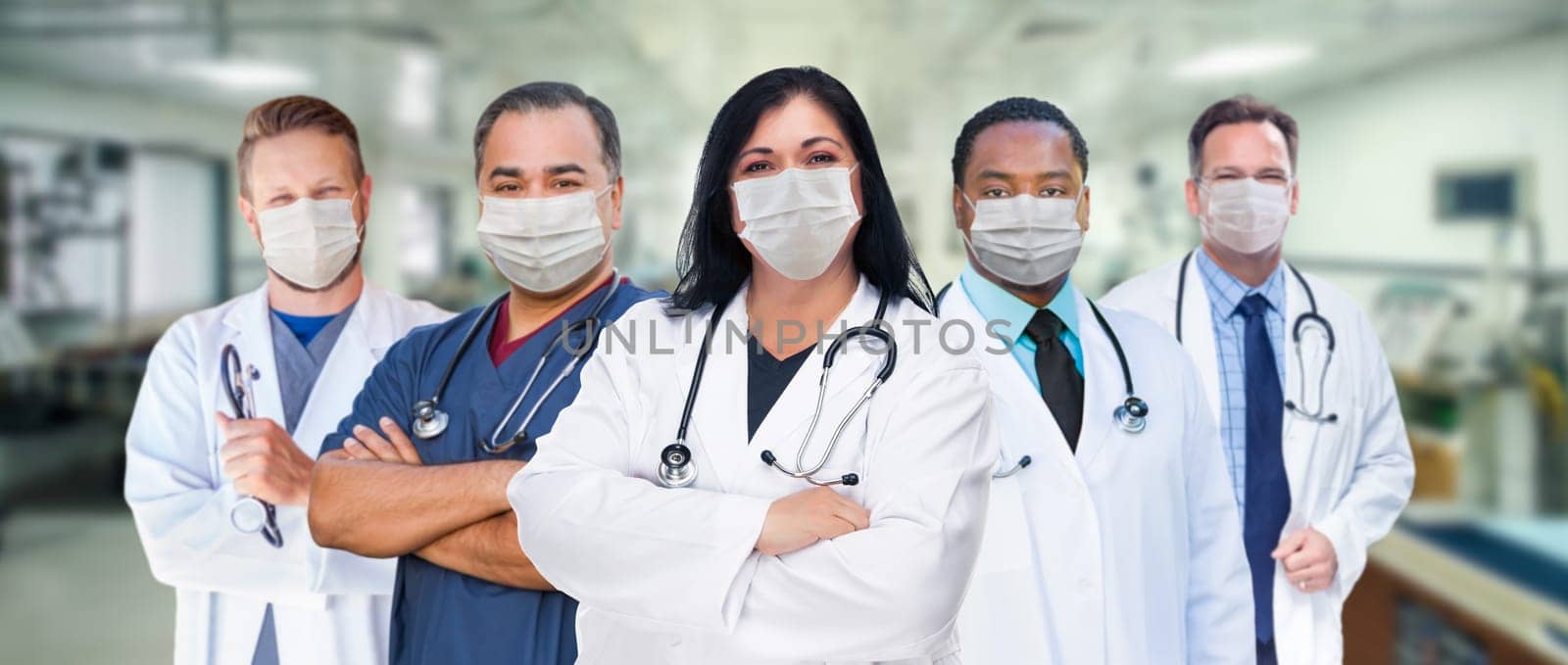 Variety of Medical Healthcare Workers Wearing Medical Face Masks Amidst the Coronavirus Pandemic Within Hospital.