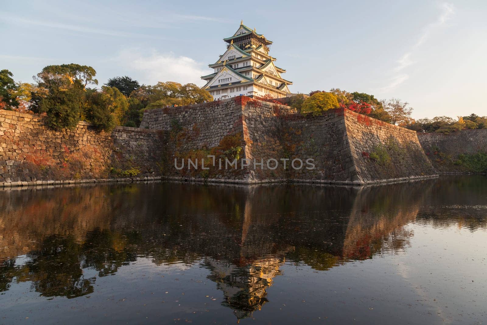 This photo was shot from Osaka Castle, Japan in the evening. The soft sunlight touch the castle is so beautiful.