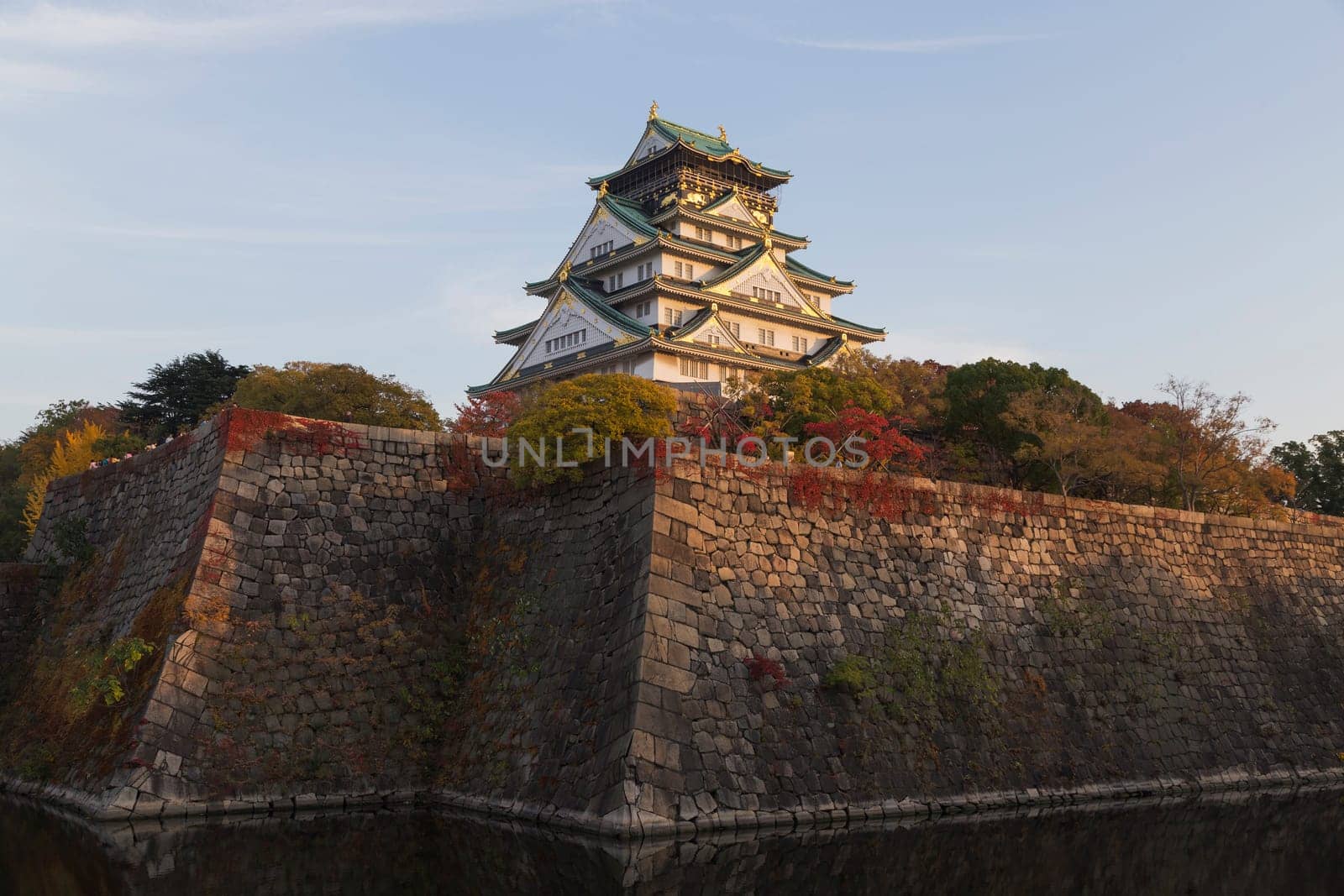 This photo was shot from Osaka Castle, Japan in the evening. The soft sunlight touch the castle is so beautiful.