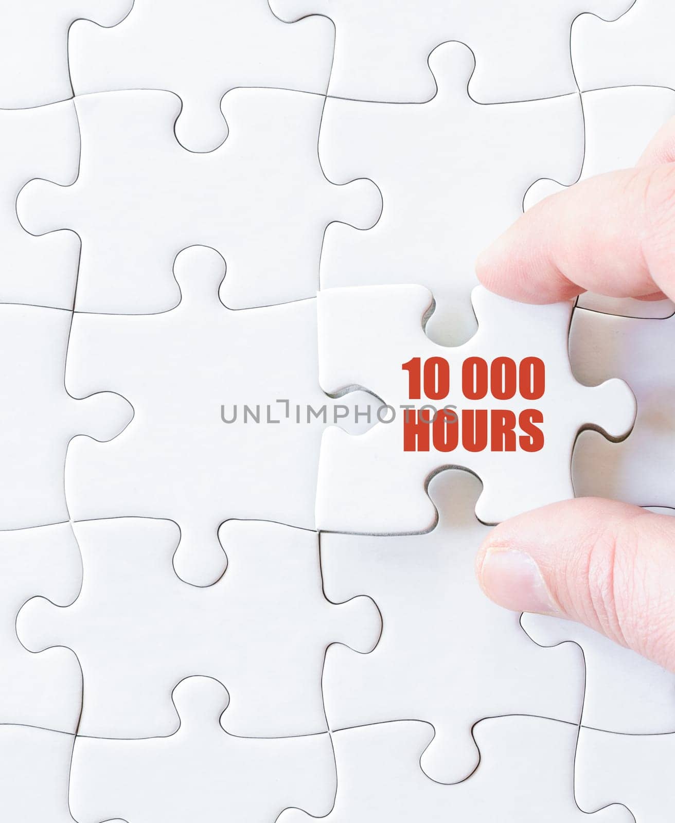 Last puzzle piece with text Ten Thousand Hours. Concept image for achieving mastery in a field