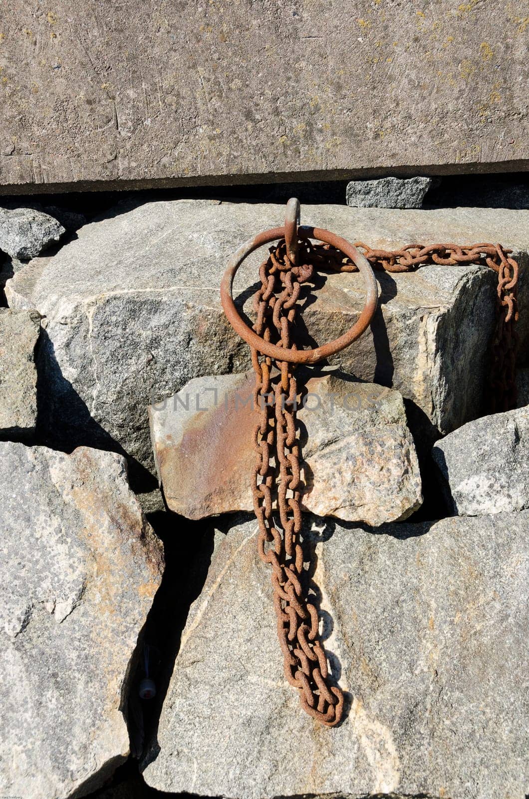 Old rusty chain to lock the boat in the harbour
