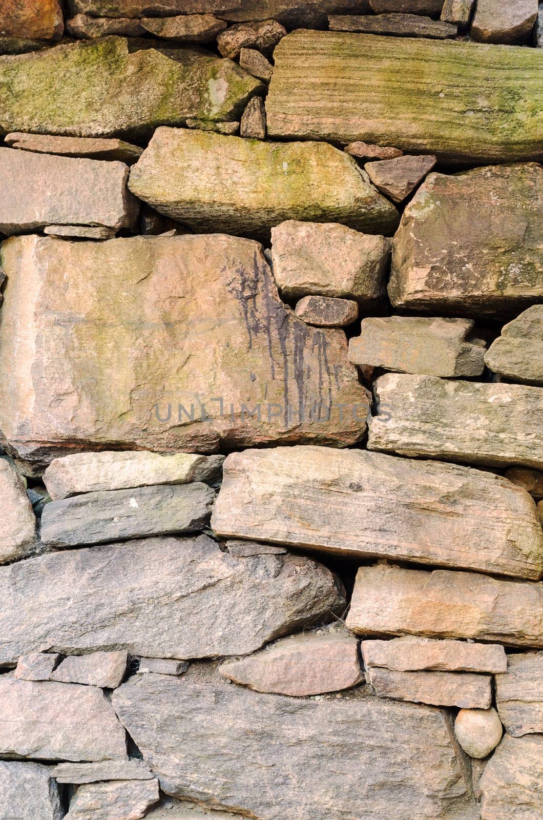 one old wall made of stone and hand made