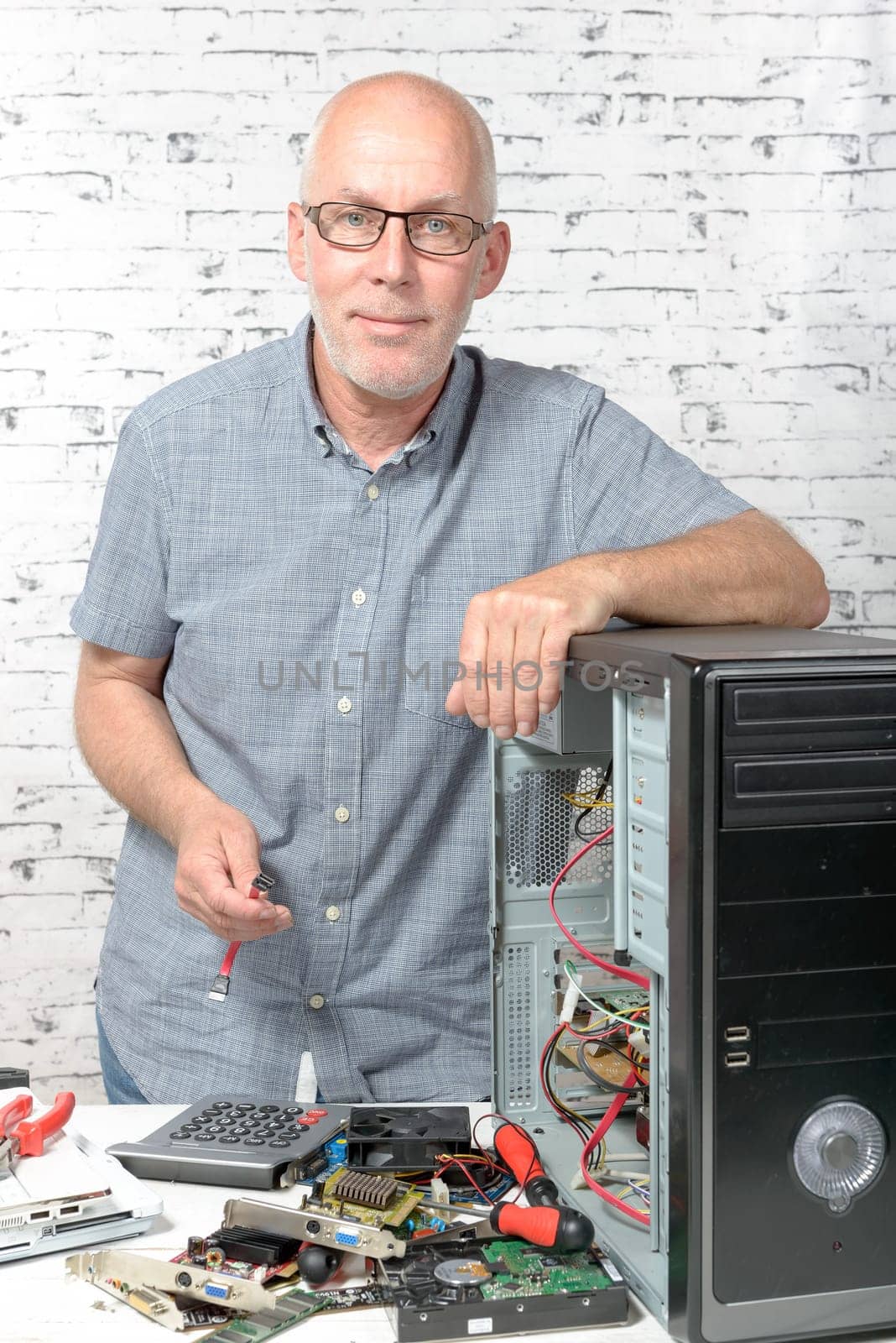 a technician repairing a computer with different tools