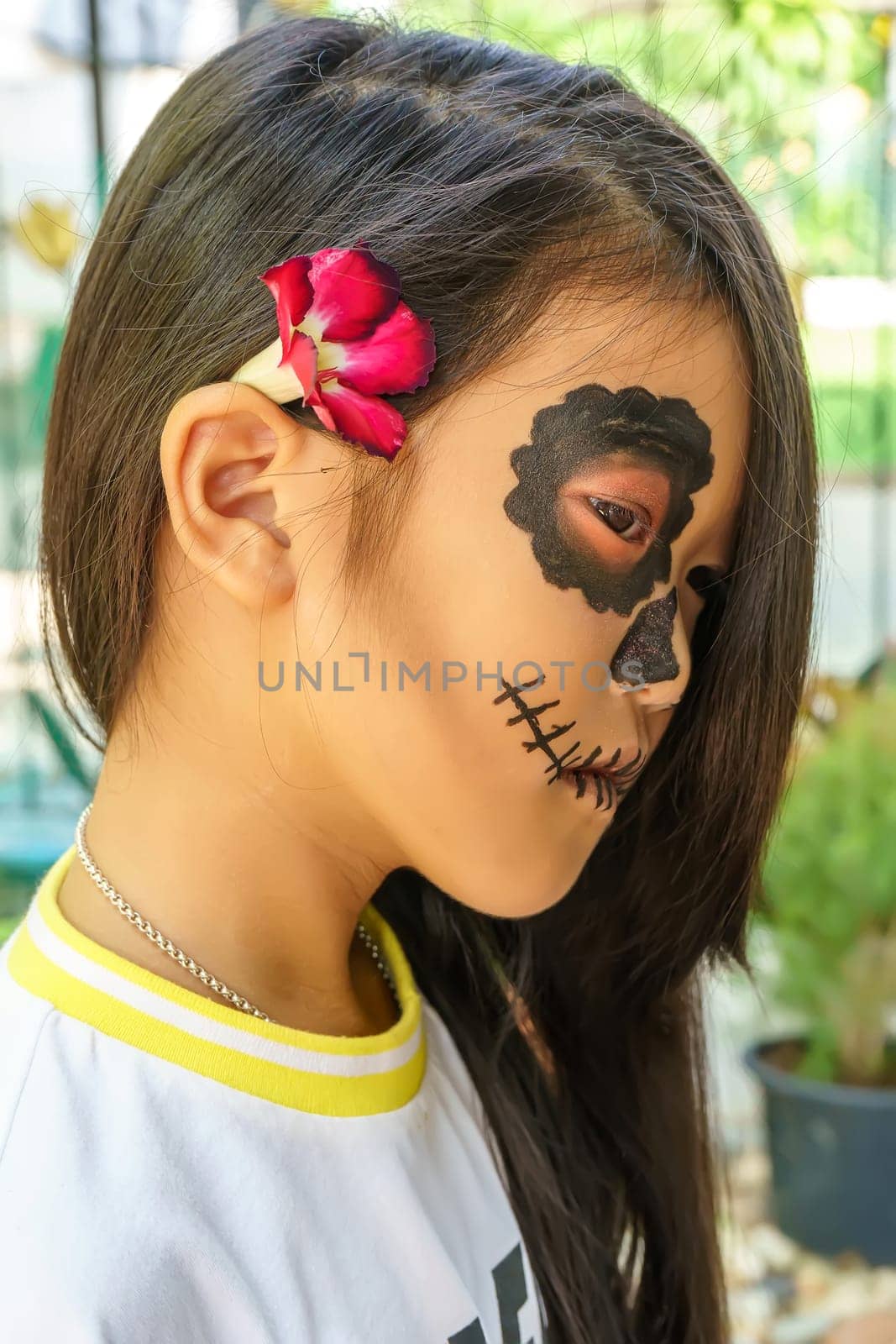 Close up the attractive girl in the sugar skull makeup. Day of The Dead. Halloween.