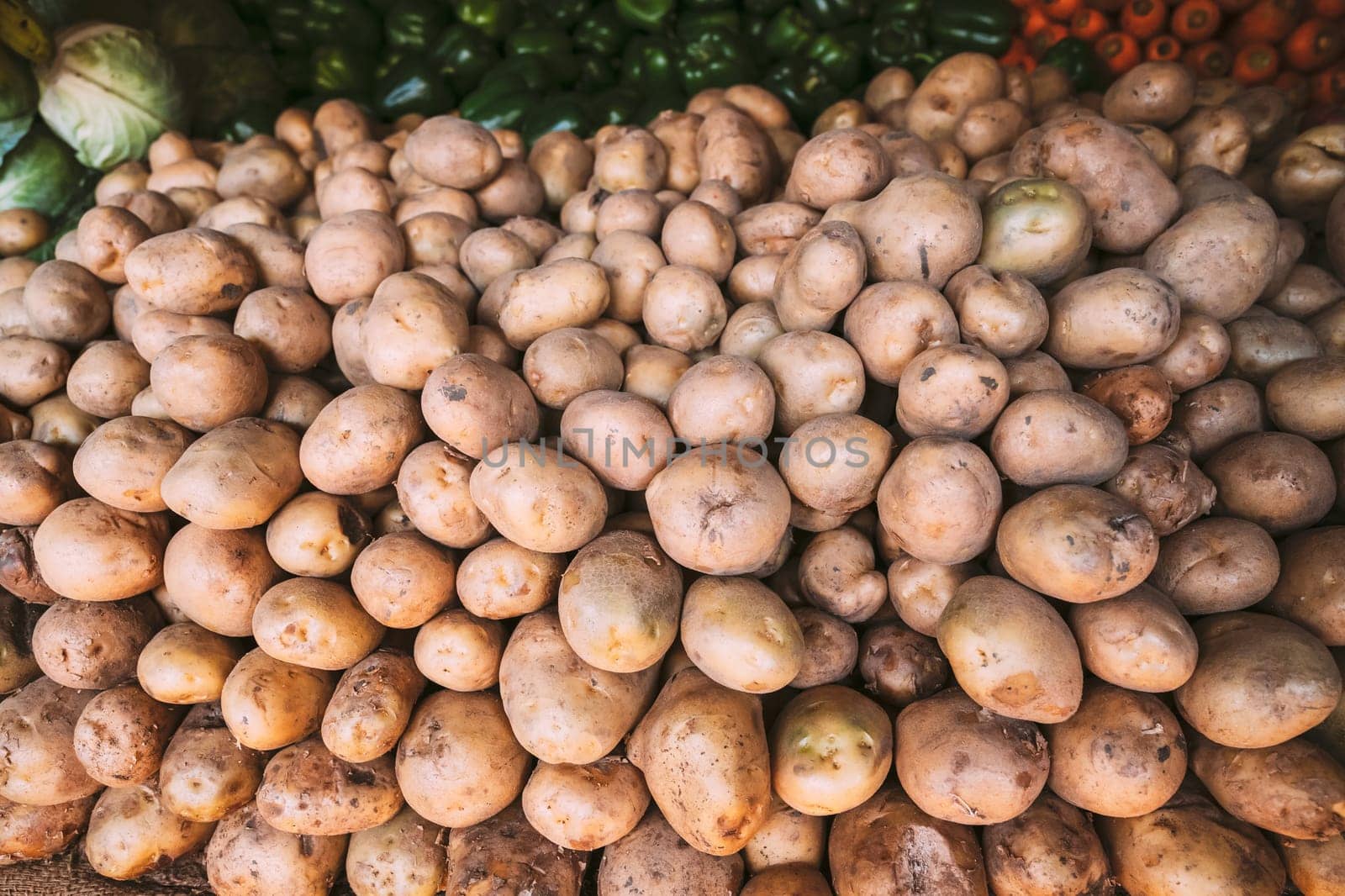 Organic Brown Potatoes On Local Agricultural Vegetable Market. Autumn Harvest Potatoes Background