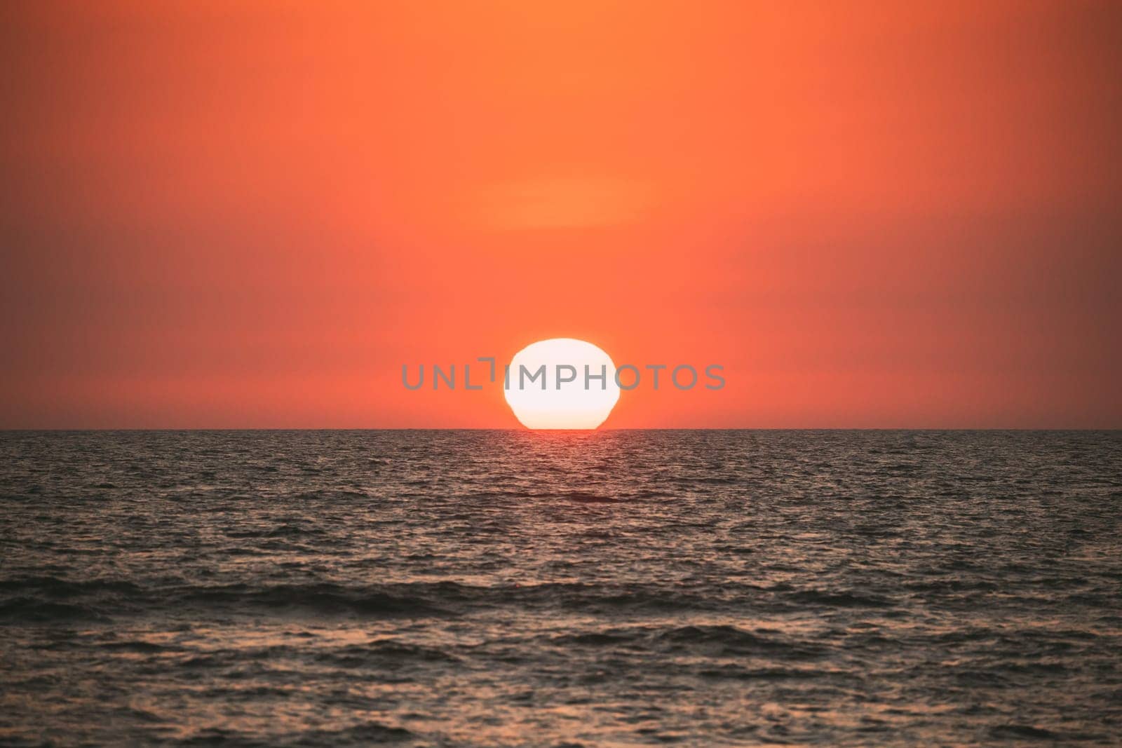 Natural Color Sunset Sunrise Sky Over Sea. Seascape With Shining Setting Sun On Sea Horizon.