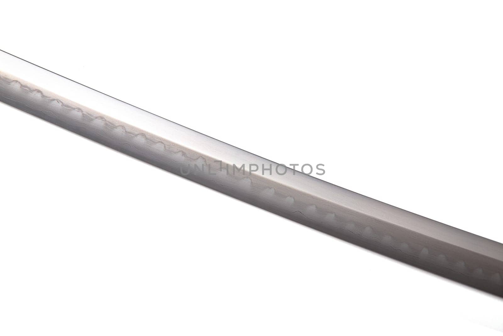 Japanese sword blade (made in China) on white background. Soft focus The blacksmith forged several folds until several layers were formed. Can be seen clearly on the surface.
