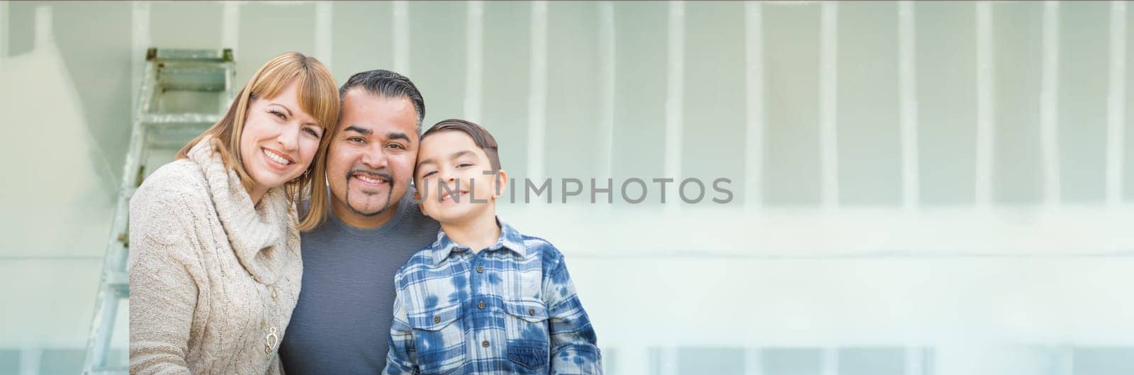 Young Biracial Family Inside Room with New Sheetrock Drywall and Ladder.