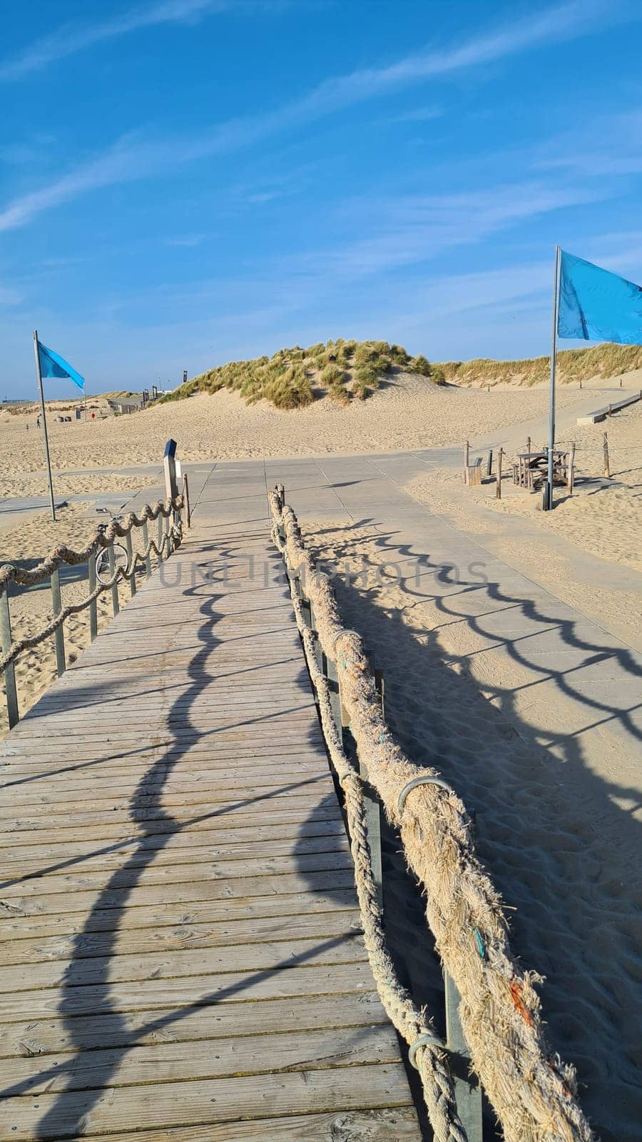 View over the sea from the dune over North Sea and canal in Ouddorp, Zeeland province, The Netherlands. Outdoor scene of coast in Europe nature.