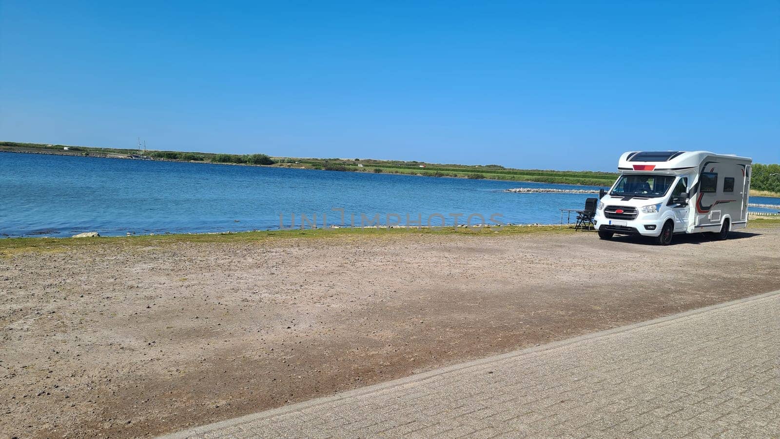 View over the sea from the dune over North Sea and canal in Ouddorp, Zeeland province, The Netherlands. Outdoor scene of coast in Europe nature.