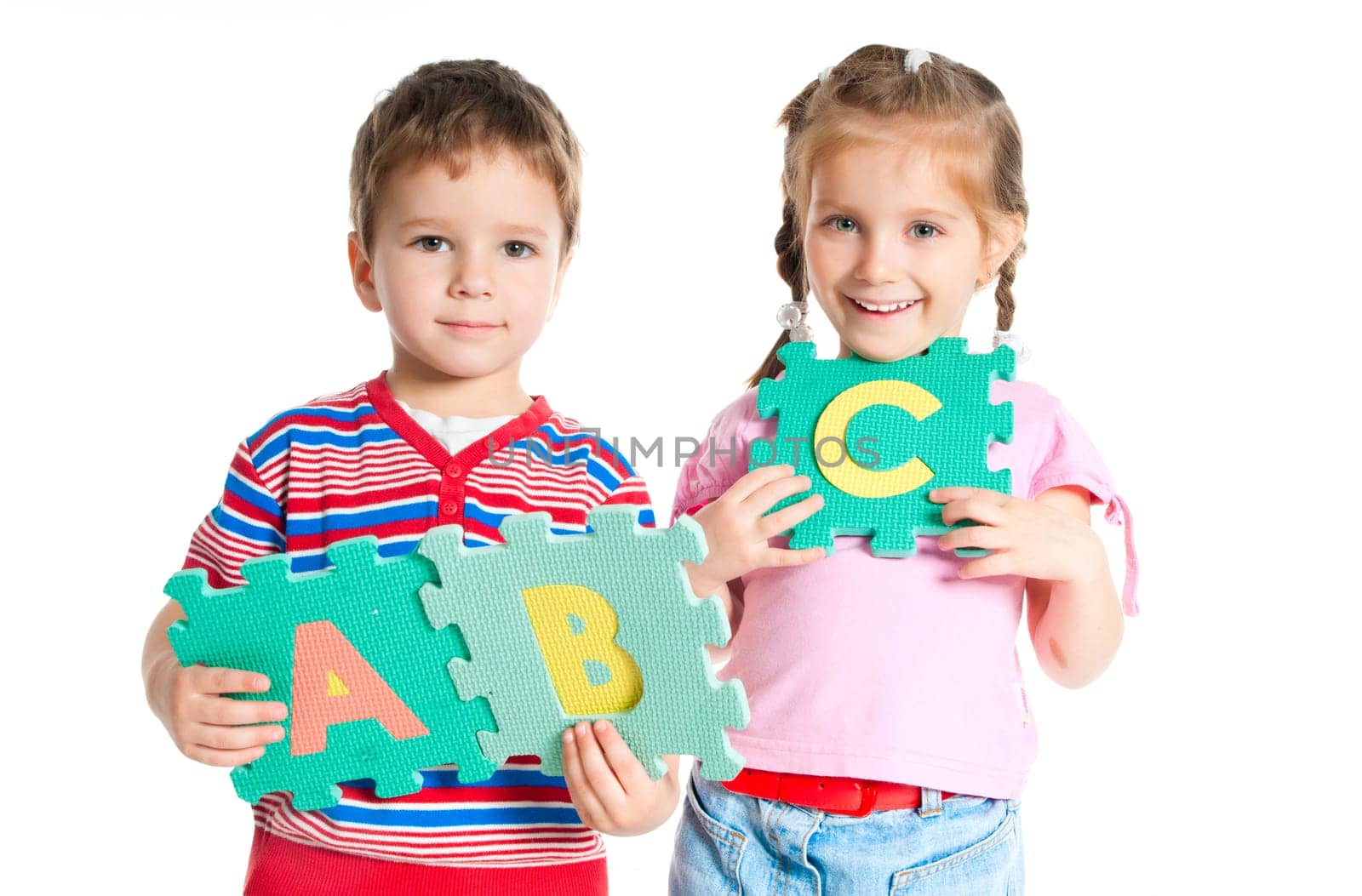 boy and girl are holding colorful letters