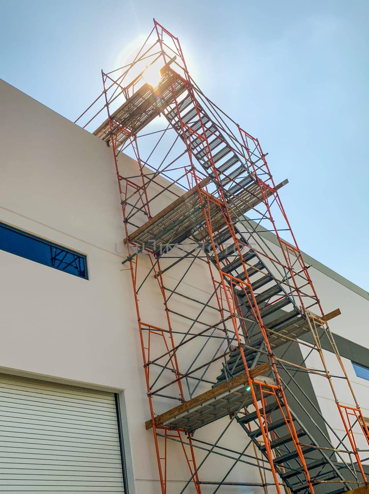 Industrial Construction Scaffolding and Ladder Along Building