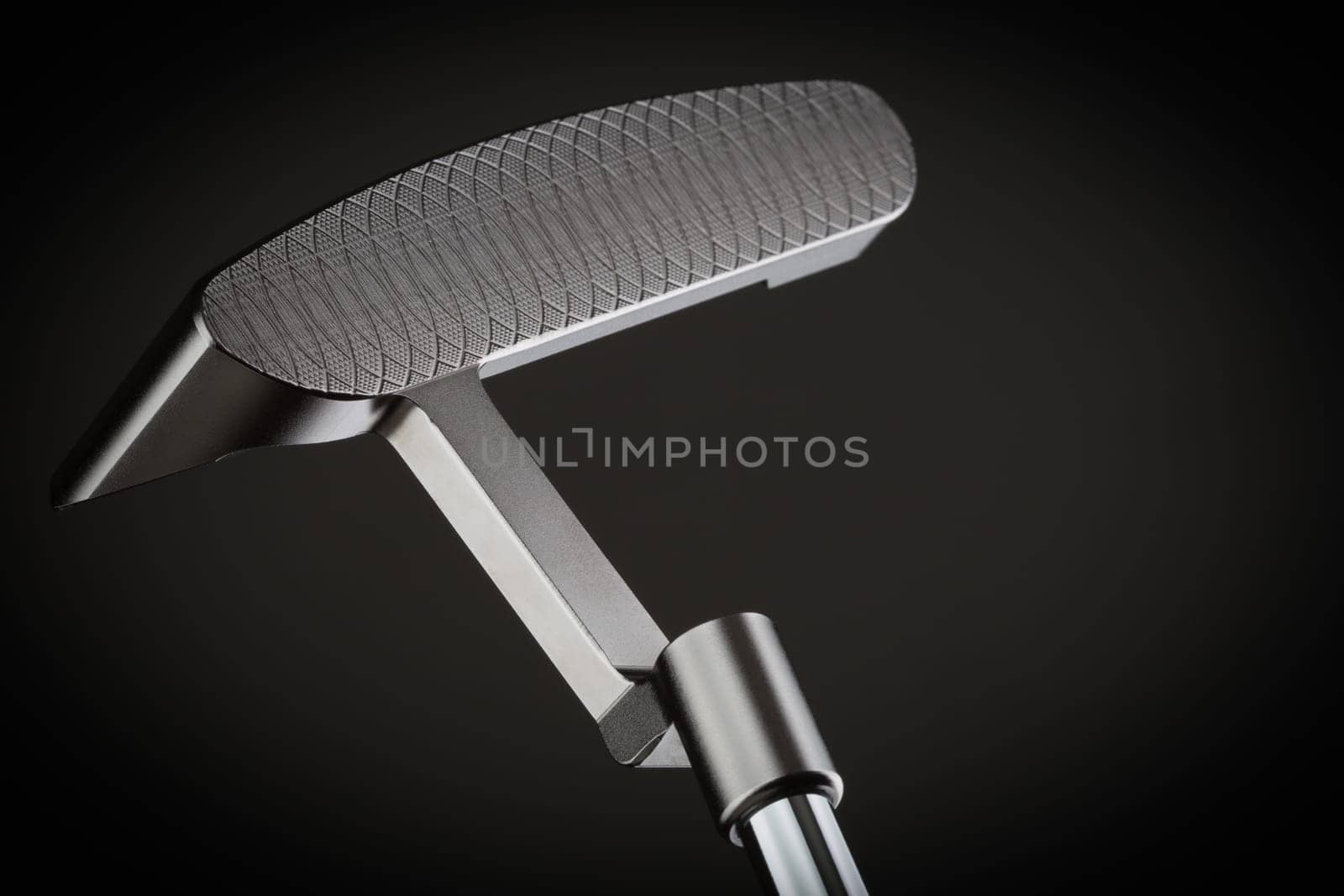 Face of Golf Club Putter On A Dark Background.