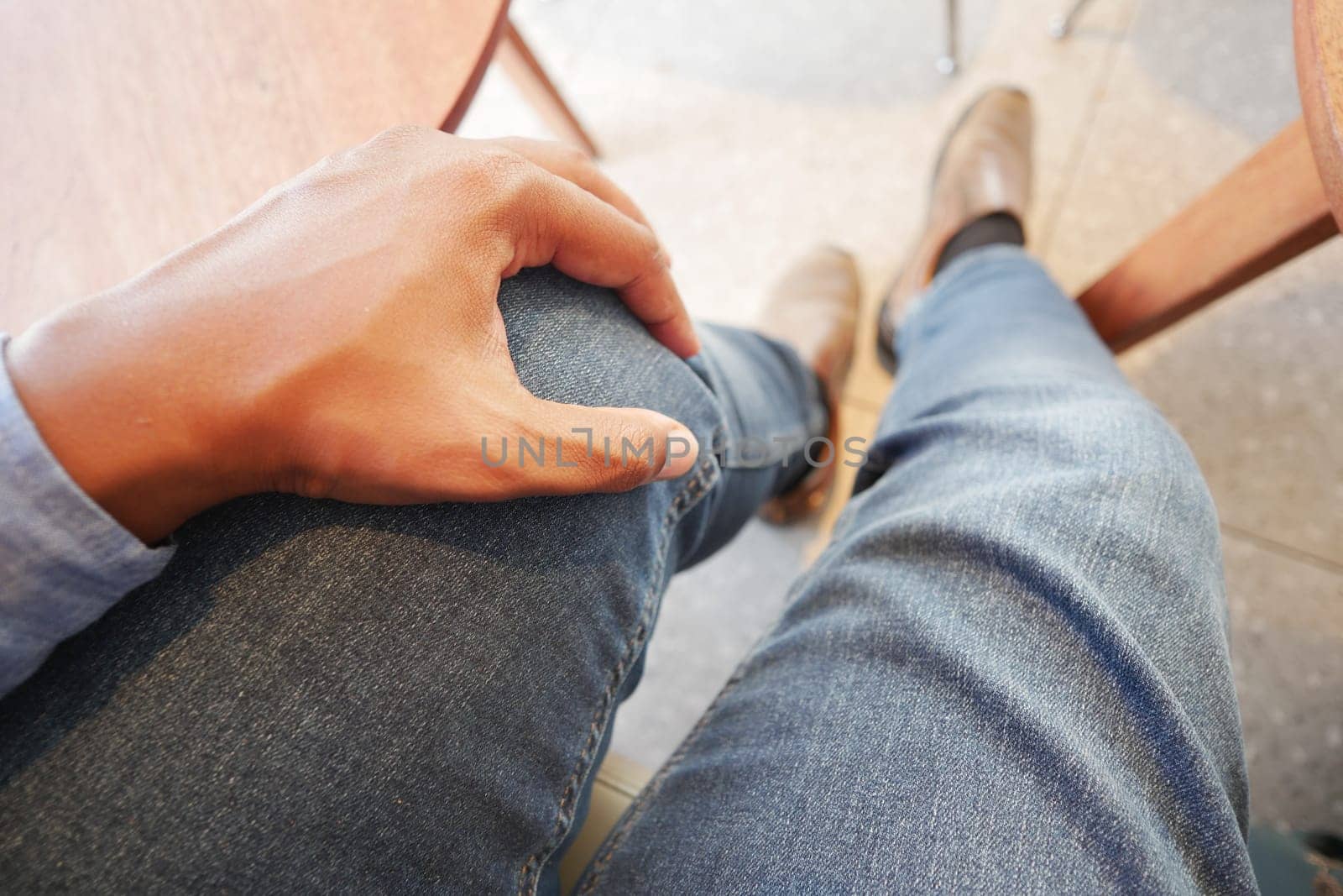 Man holding his painful knee.
