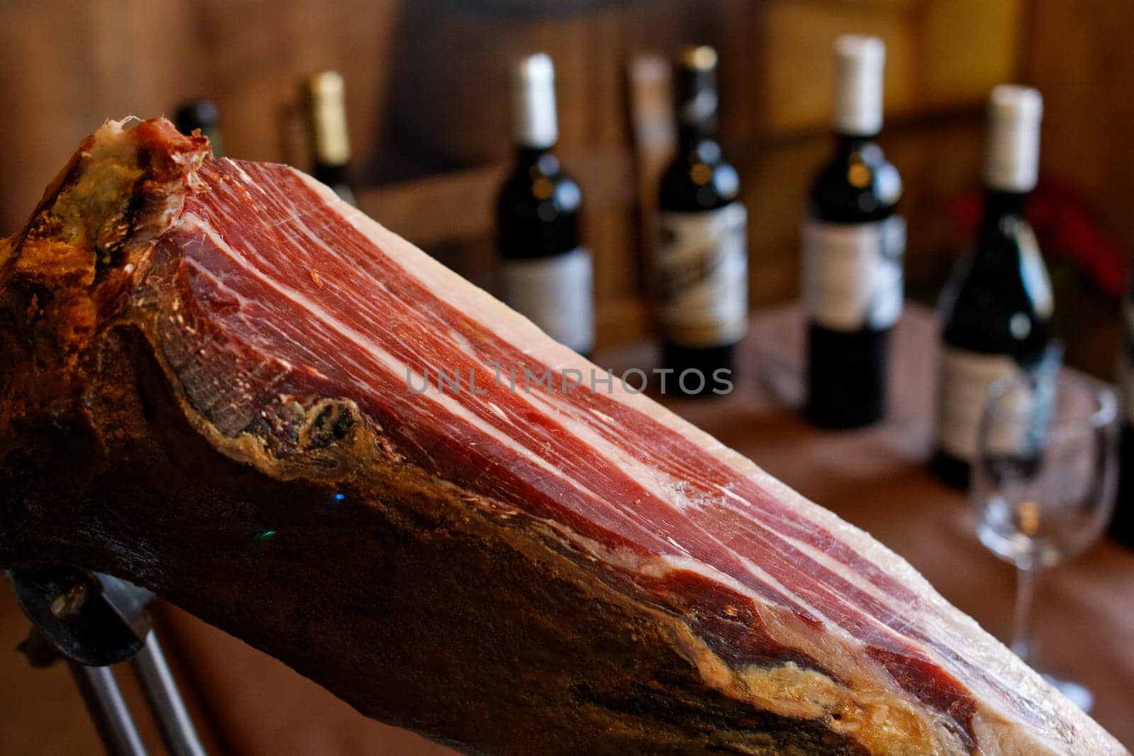 spanish ham jam on close up with bunch of wines on background