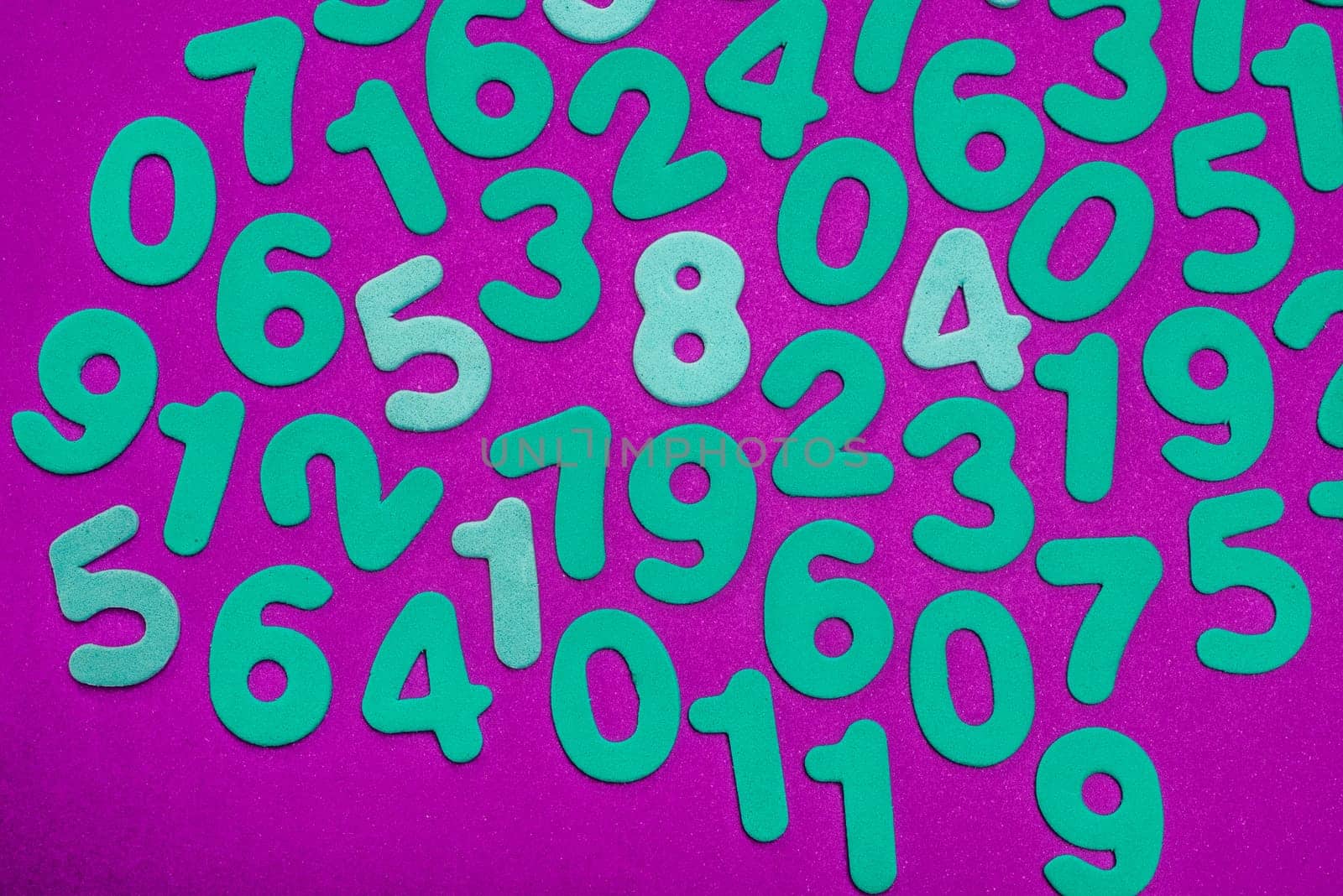 A mix of cyan numbers of single digits all on a magenta background.