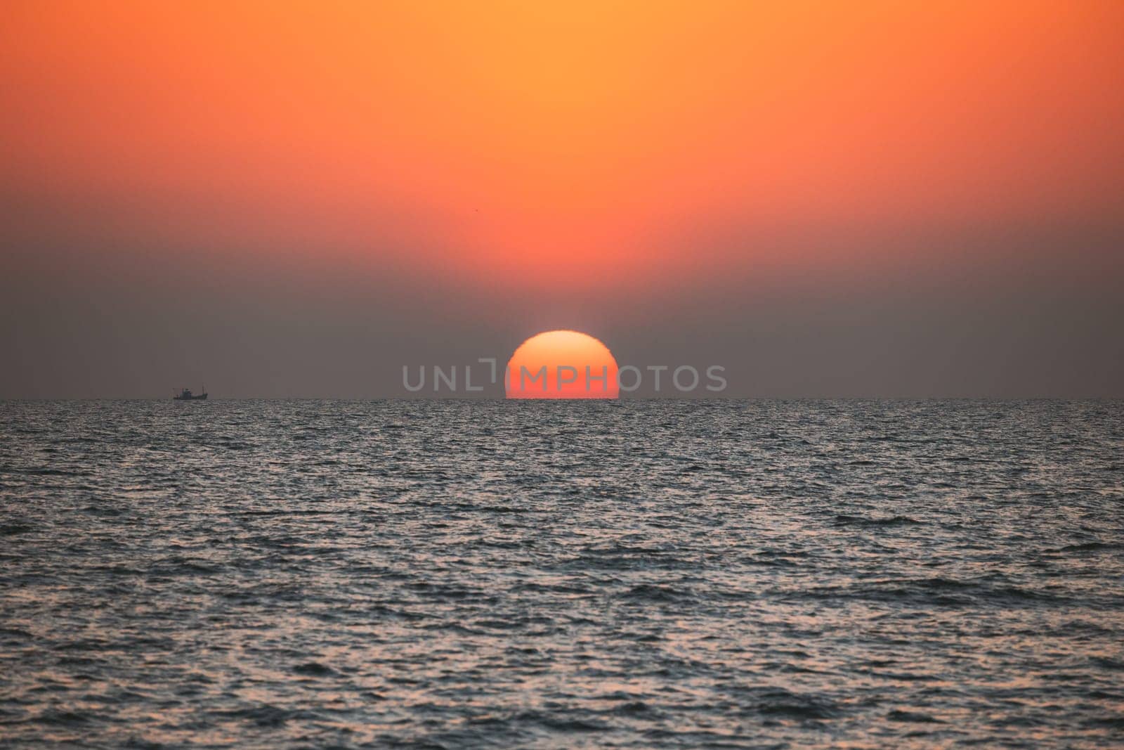 Sundown Above Sea Horizon At Sunset. Natural Sunrise Sky Warm Colors Over Ocean. Big Sun Over Sea Waters