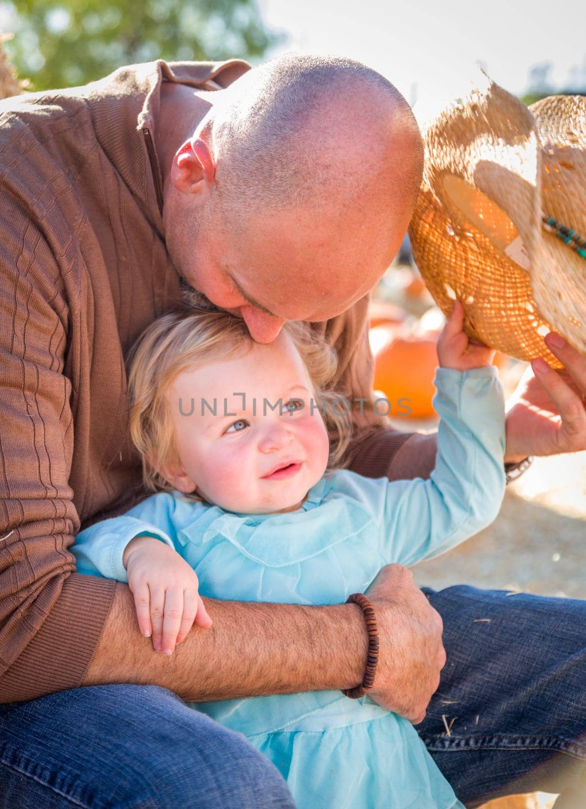 Adorable Young Family Enjoys a Day at the Pumpkin Patch.
