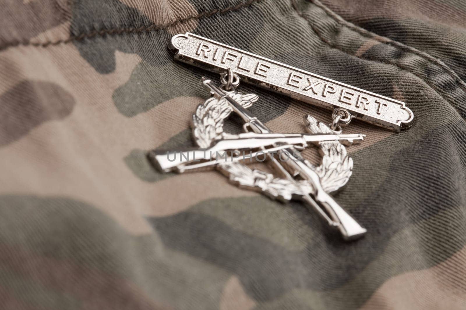 Rifle Expert War Medal on a Camouflage Material.