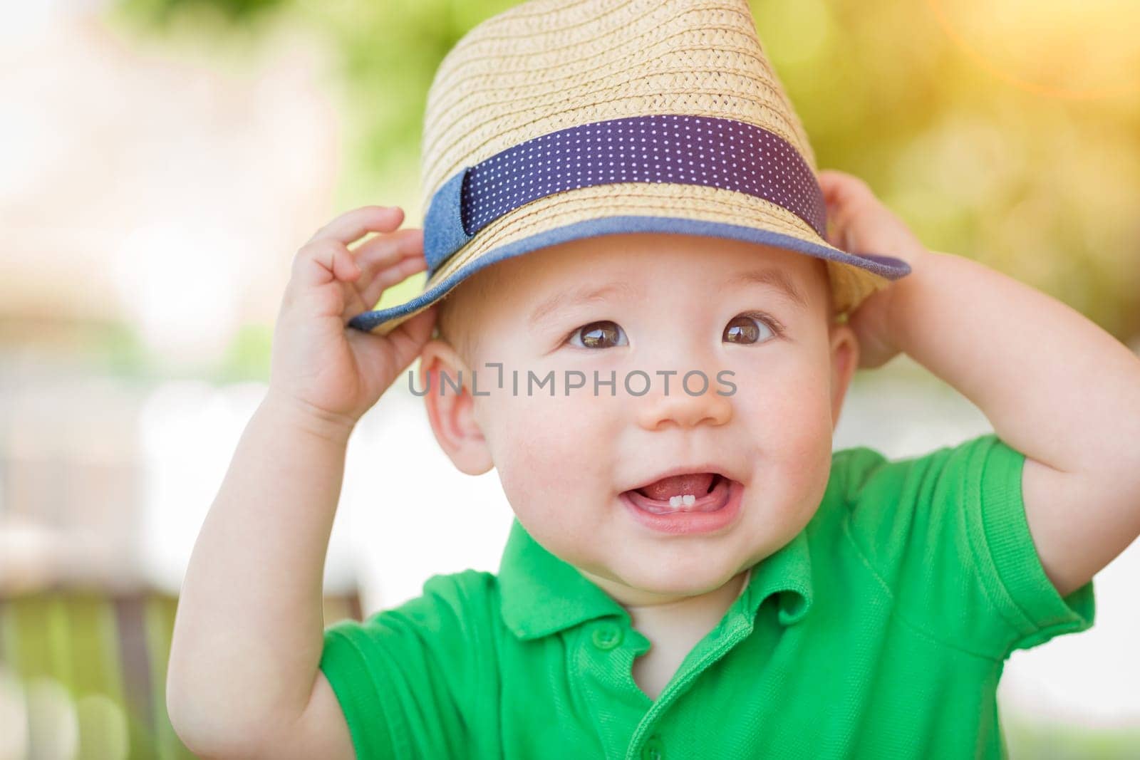 Portrait of A Happy Mixed Race Chinese and Caucasian Baby Boy Wearing His Hat