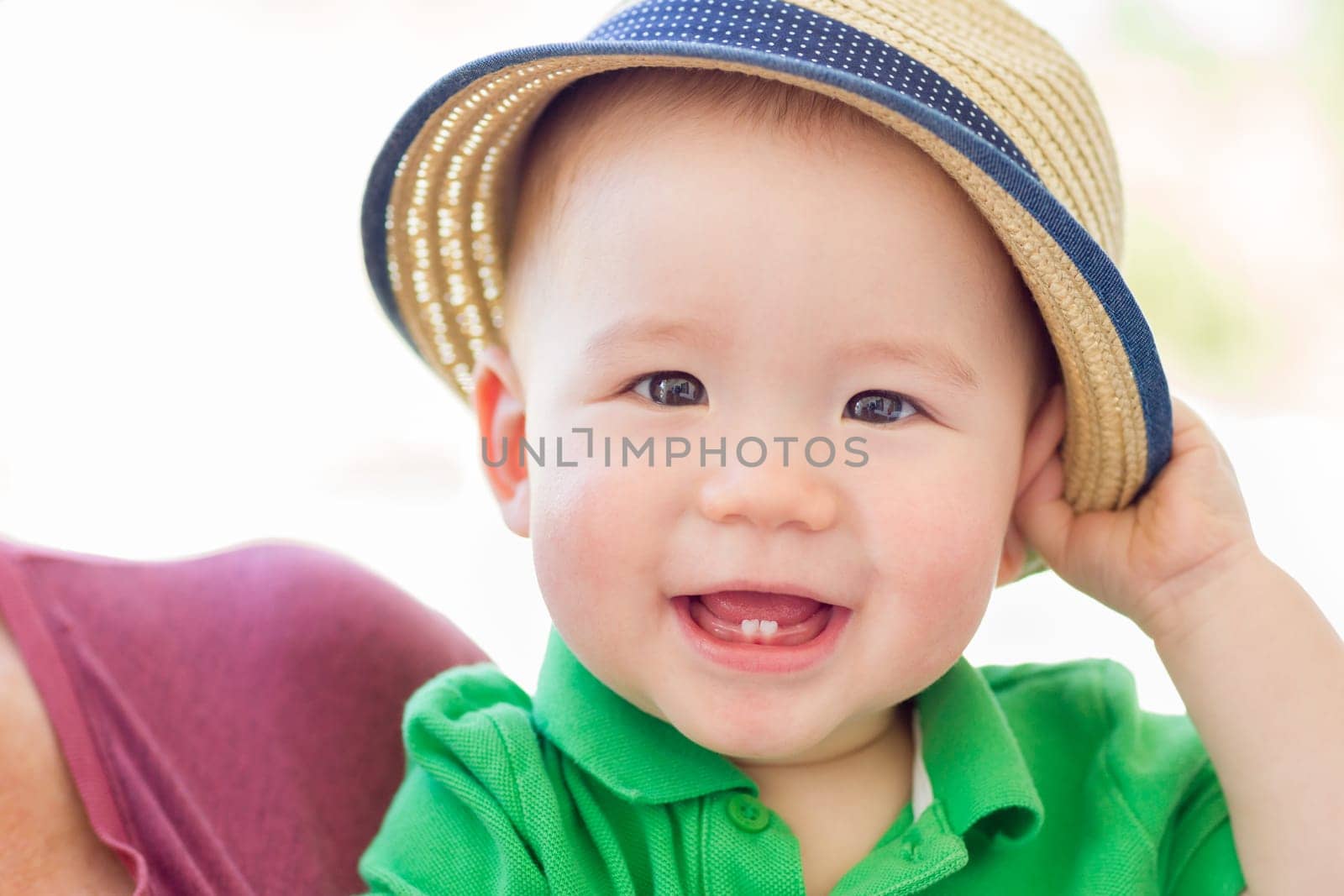 Portrait of A Happy Mixed Race Chinese and Caucasian Baby Boy Wearing His Hat
