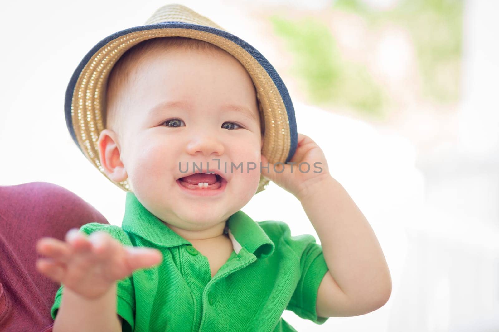 Portrait of A Happy Mixed Race Chinese and Caucasian Baby Boy Wearing His Hat