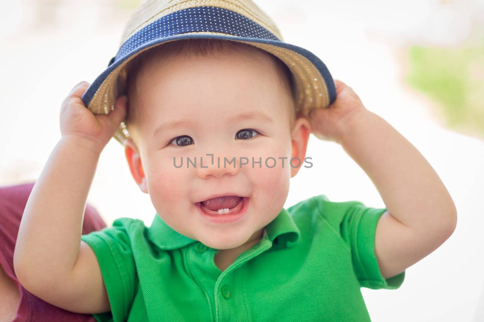 Portrait of A Happy Mixed Race Chinese and Caucasian Baby Boy Wearing His Hat