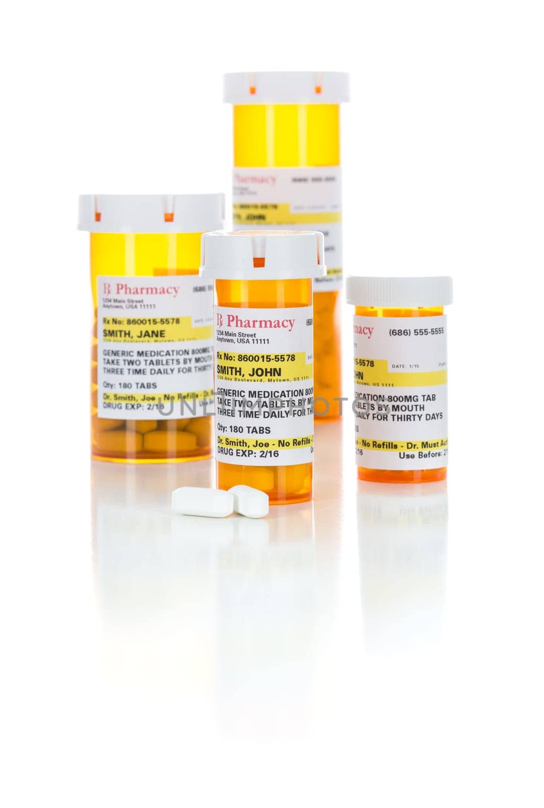 Non-Proprietary Medicine Prescription Bottles and Pills Isolated on a White Background.