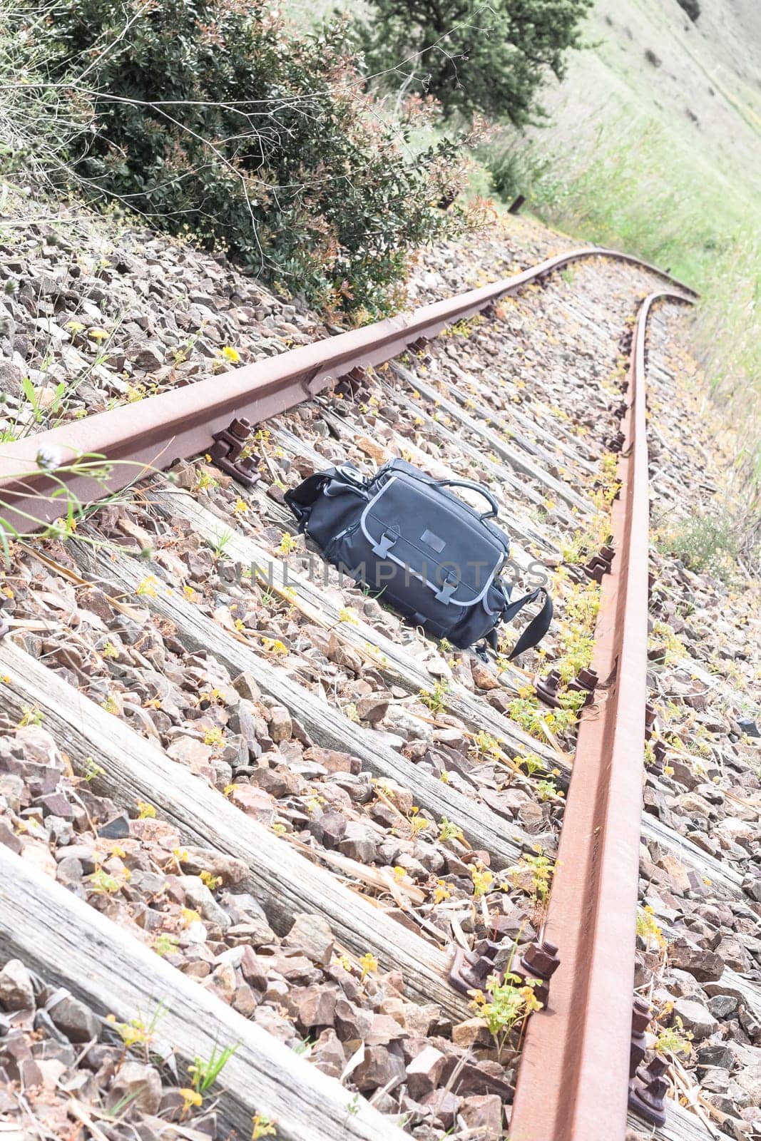 abandoned track bag. bag left on the tracks. Concept of lonely travel