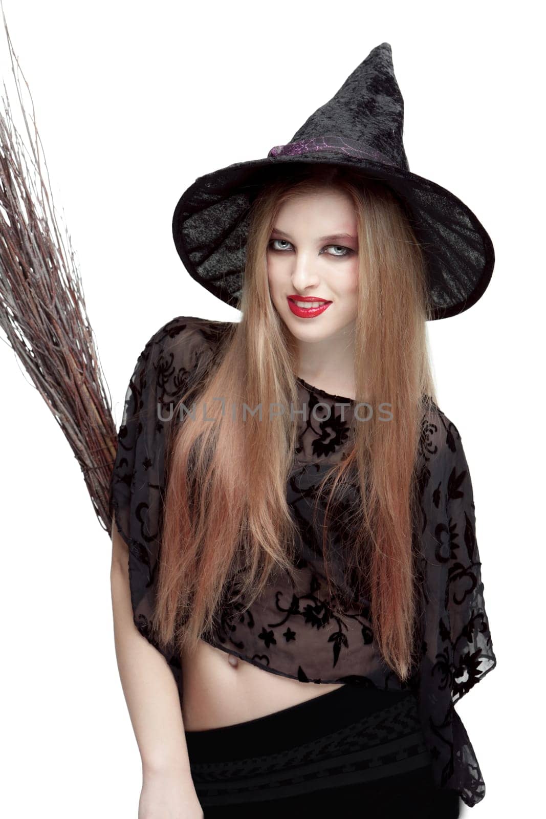 Girl in black witch costume with a broom isolated on white background. Halloween